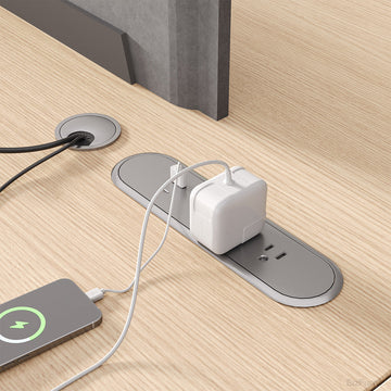 Close-Up Built-In Power Outlet on Wood Office Desktop
